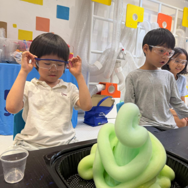 Smiling kids enjoying a Newtonshow science camp activity