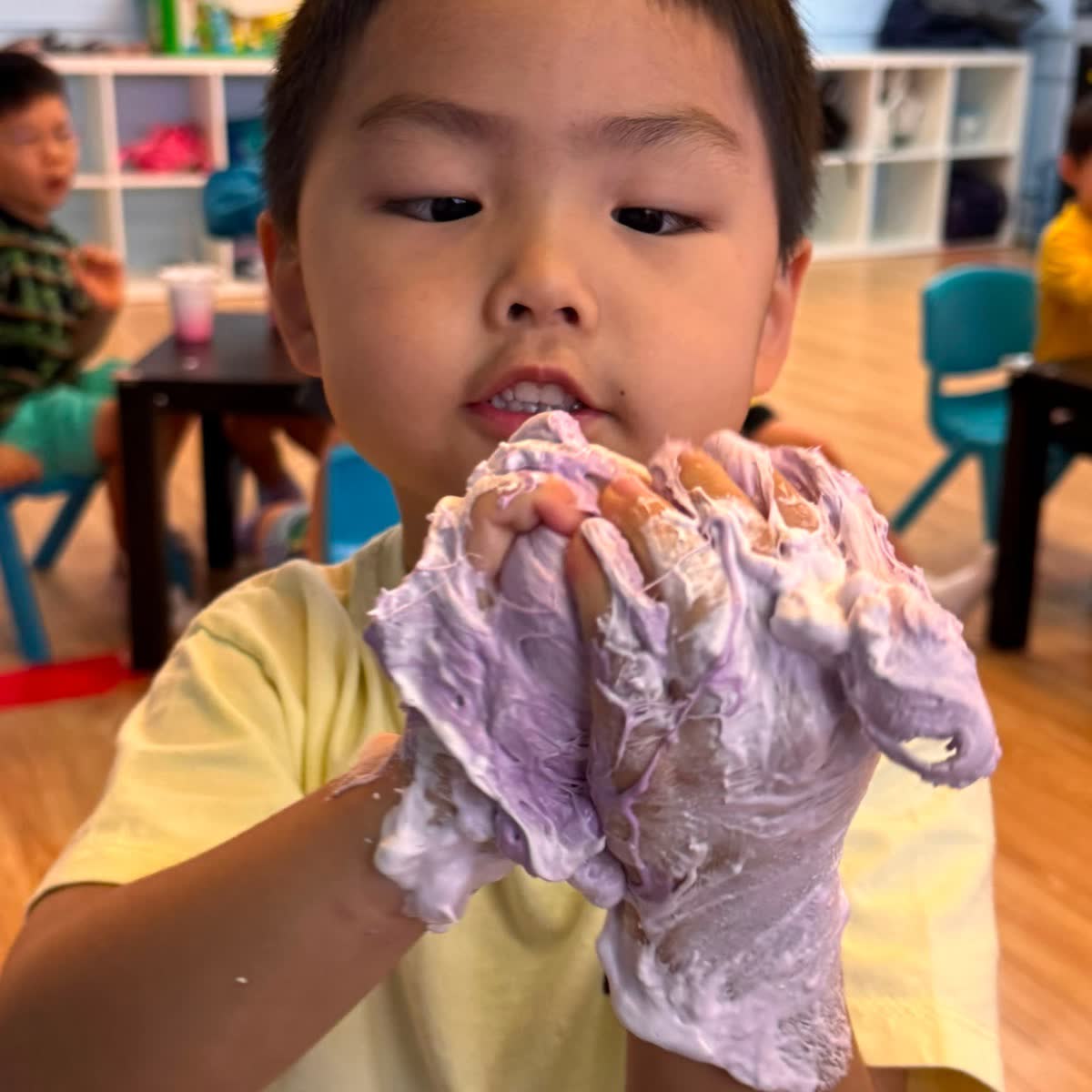 Child stretching the purple slime he made at a Newtonshow camp