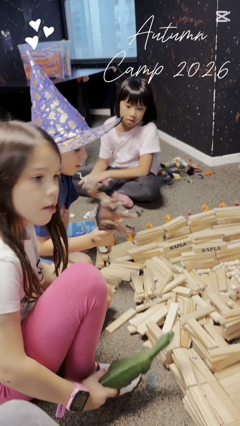 Children building a giant wooden-block structure at a Newtonshow camp